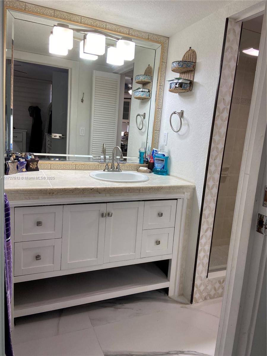 17021 North Bay Road, Unit 627 Sunny Isles Beach, FL 33160 - Photo 18 of 24 a bathroom with a sink and a mirror
