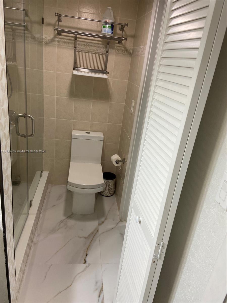 17021 North Bay Road, Unit 627 Sunny Isles Beach, FL 33160 - Photo 21 of 24 a bathroom with a toilet and a shower