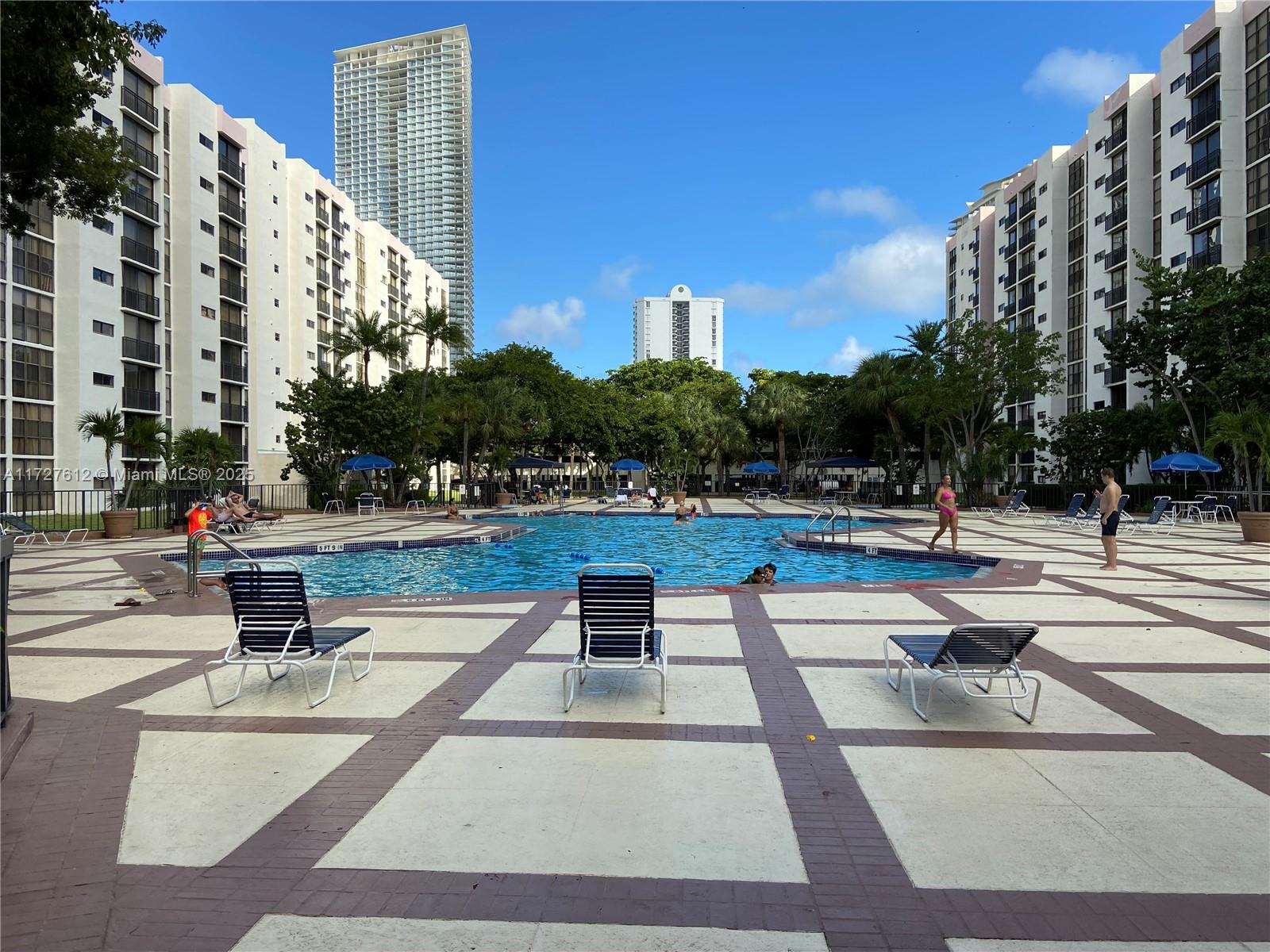 17021 North Bay Road, Unit 627 Sunny Isles Beach, FL 33160 - Photo 24 of 24 a swimming pool with outdoor seating and yard