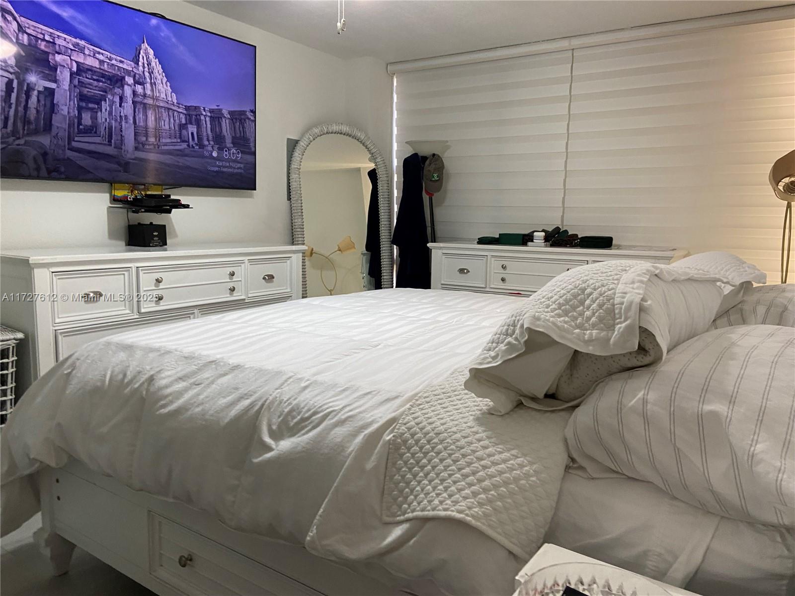 17021 North Bay Road, Unit 627 Sunny Isles Beach, FL 33160 - Photo 3 of 24 a bedroom with a bed and a dresser