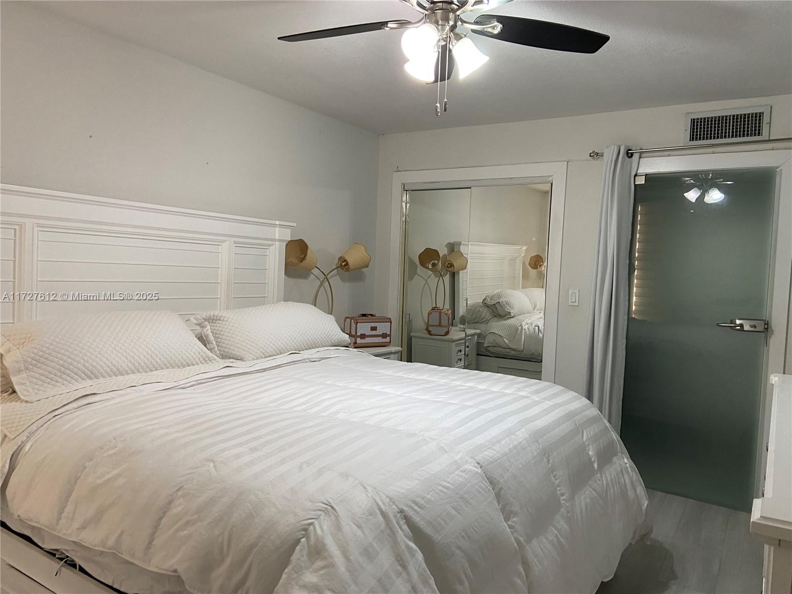 17021 North Bay Road, Unit 627 Sunny Isles Beach, FL 33160 - Photo 4 of 24 a large bed sitting in a bedroom and a chandelier