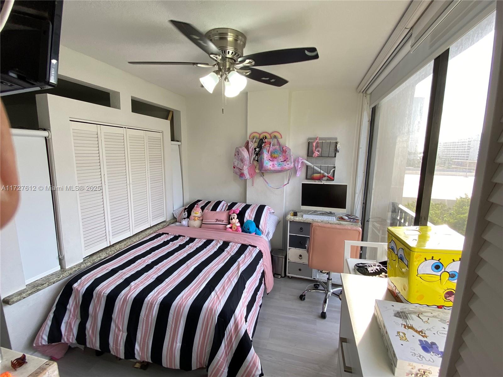 17021 North Bay Road, Unit 627 Sunny Isles Beach, FL 33160 - Photo 6 of 24 a bedroom with a bed and a chandelier