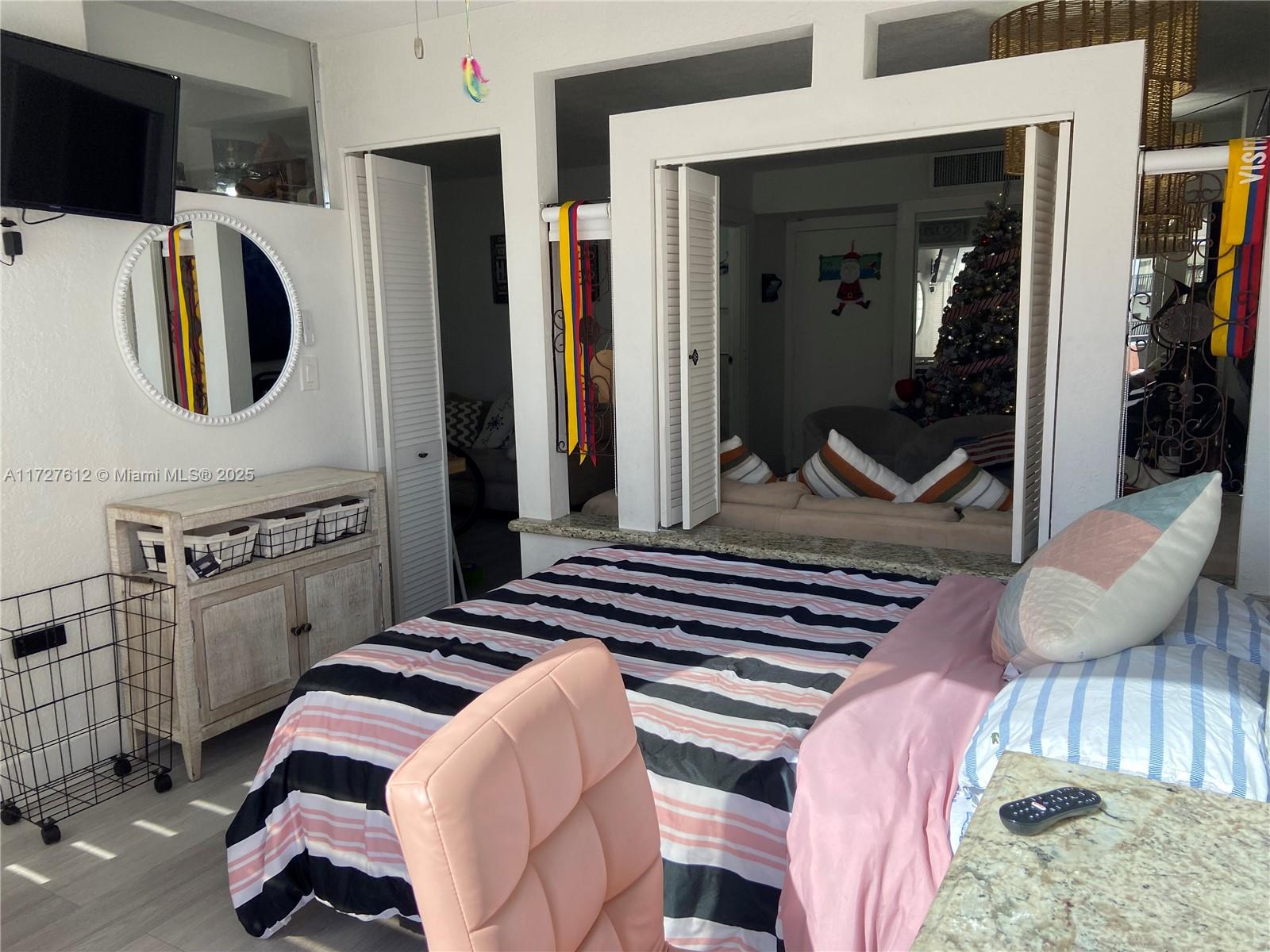 17021 North Bay Road, Unit 627 Sunny Isles Beach, FL 33160 - Photo 7 of 24 a bedroom with a bed and a television