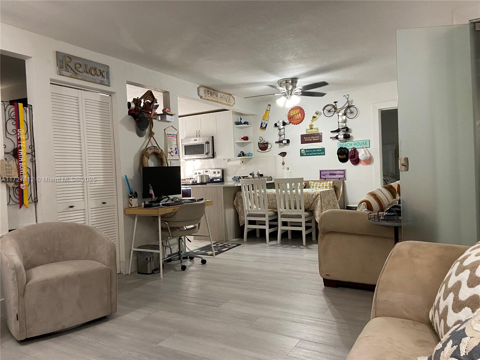 17021 North Bay Road, Unit 627 Sunny Isles Beach, FL 33160 - Photo 8 of 24 a living room with furniture and a flat screen tv
