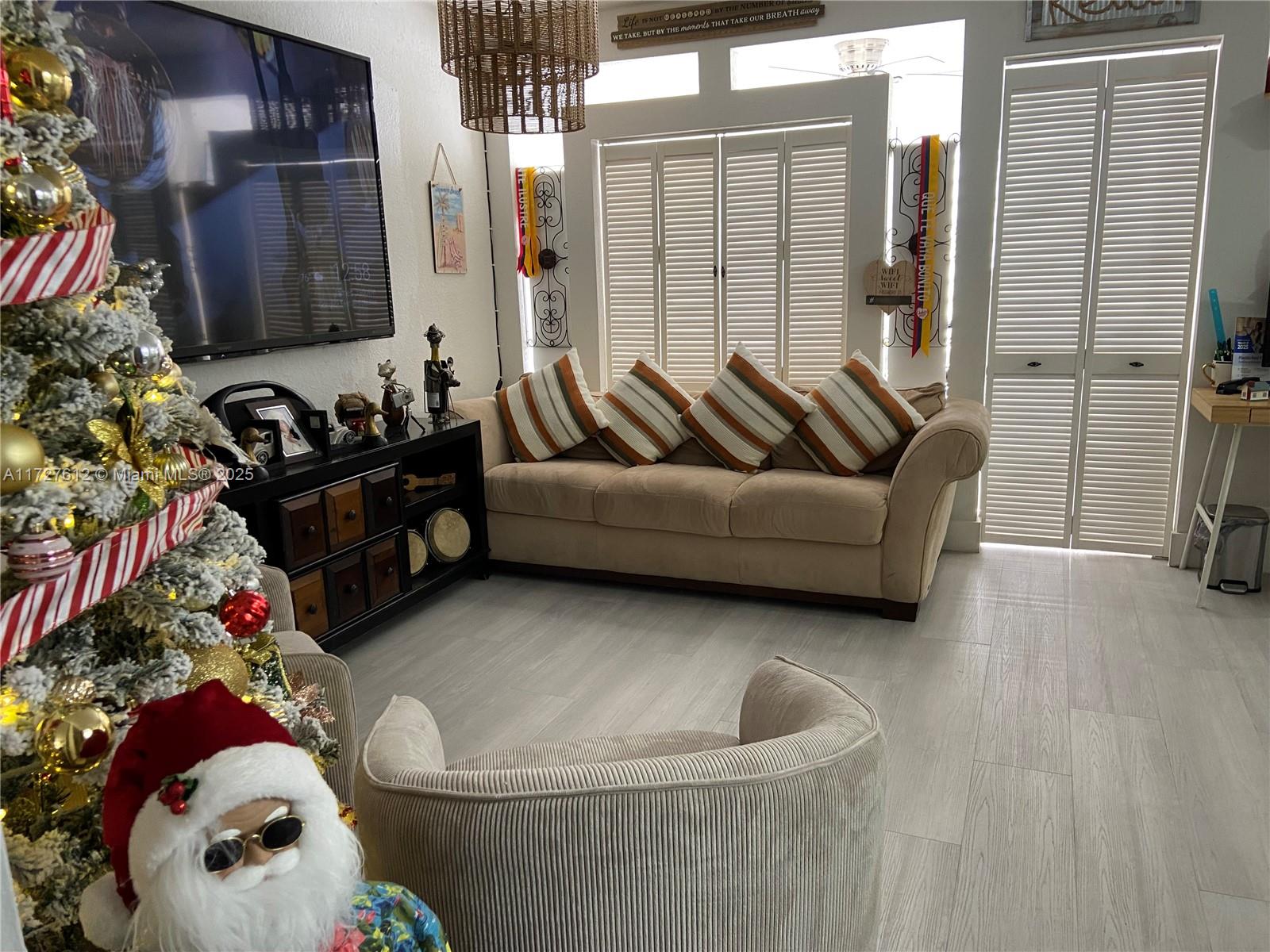 17021 North Bay Road, Unit 627 Sunny Isles Beach, FL 33160 - Photo 9 of 24 a living room with furniture and a fireplace