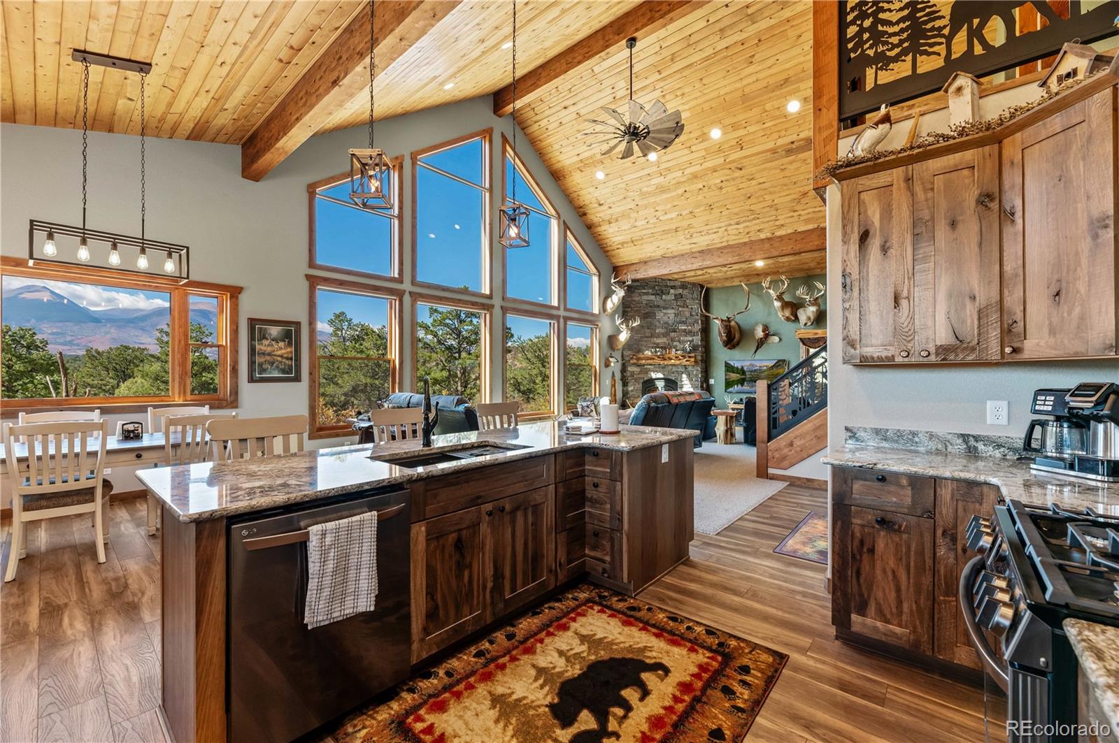 1310 Sunrise Ridge Cotopaxi, CO 81223 - Photo 33 of 50 a kitchen with a sink and wooden cabinets