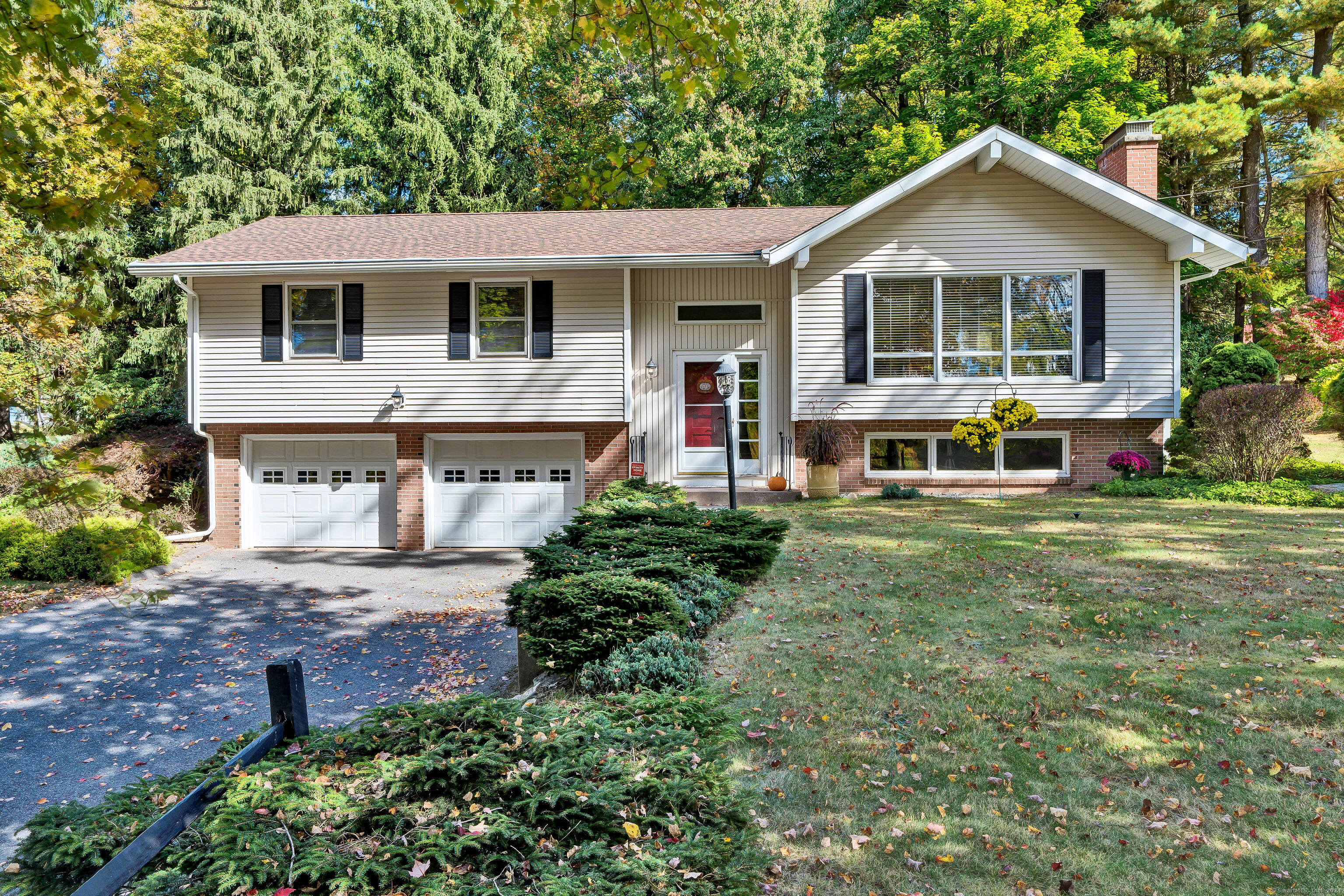 a front view of a house with a yard table and chairs