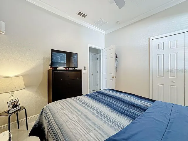 a bedroom with a bed and a flat screen tv