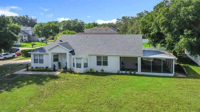an aerial view of residential houses with outdoor space and river
