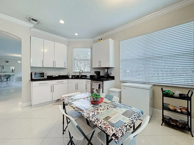 a kitchen with a sink stove and white cabinets
