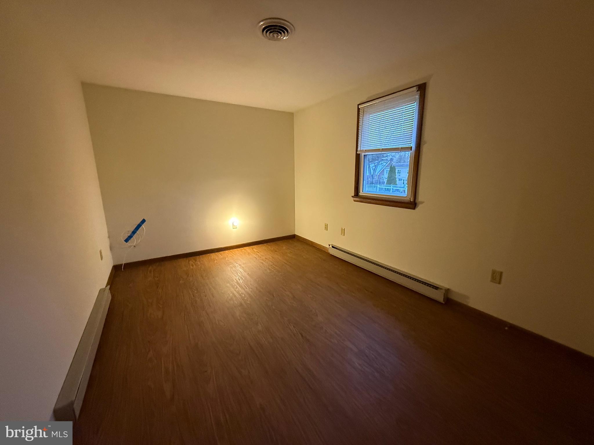 344 North Virginia Avenue Carneys Point, NJ 08069 - Photo 13 of 16 a view of an empty room with wooden floor and a window