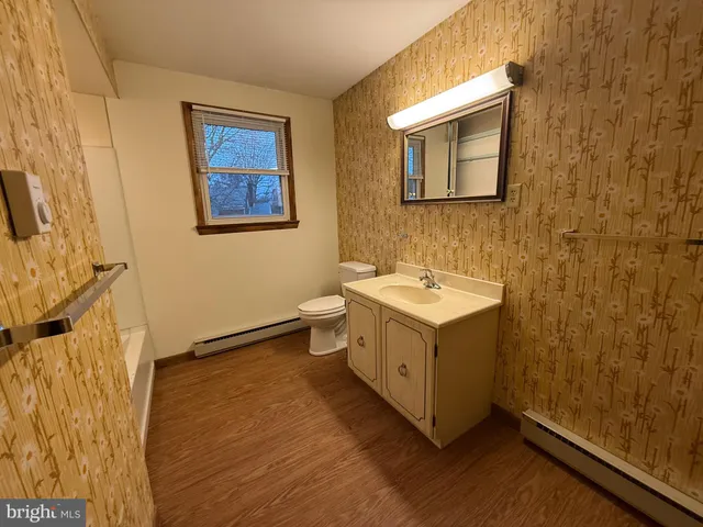 a bathroom with a sink mirror and vanity
