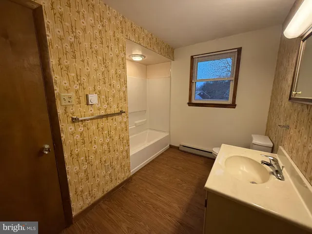 a bathroom with a sink and shower