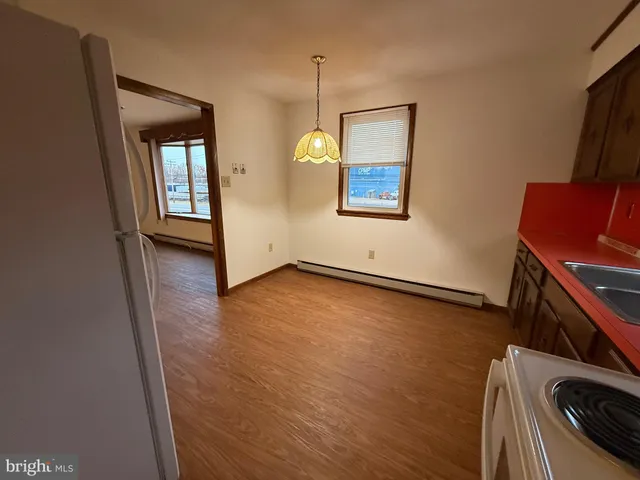 a view of a room with wooden floor and a window
