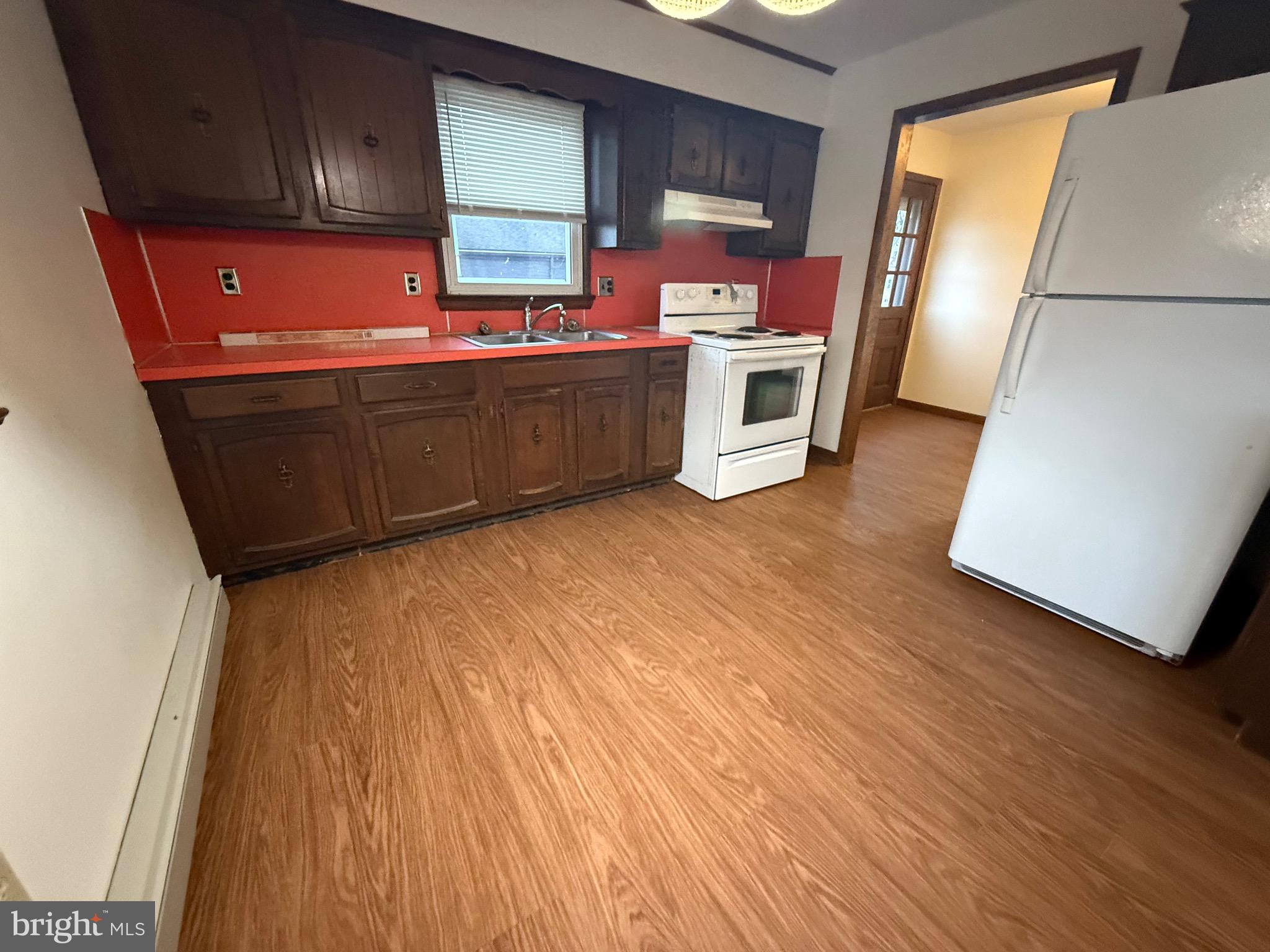 344 North Virginia Avenue Carneys Point, NJ 08069 - Photo 7 of 16 a kitchen with stainless steel appliances a stove a refrigerator and wooden floor