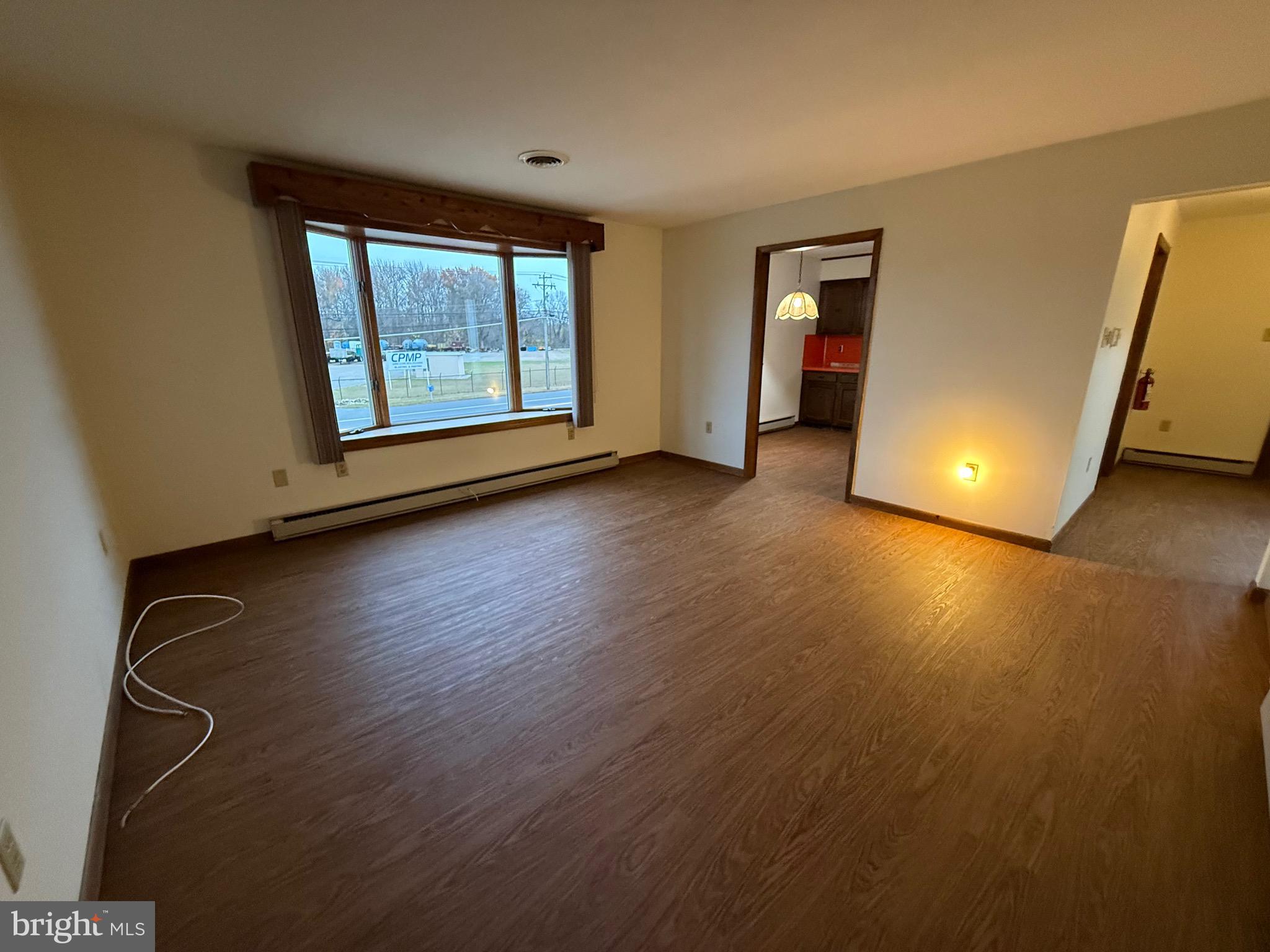 344 North Virginia Avenue Carneys Point, NJ 08069 - Photo 9 of 16 a view of an empty room with window and wooden floor