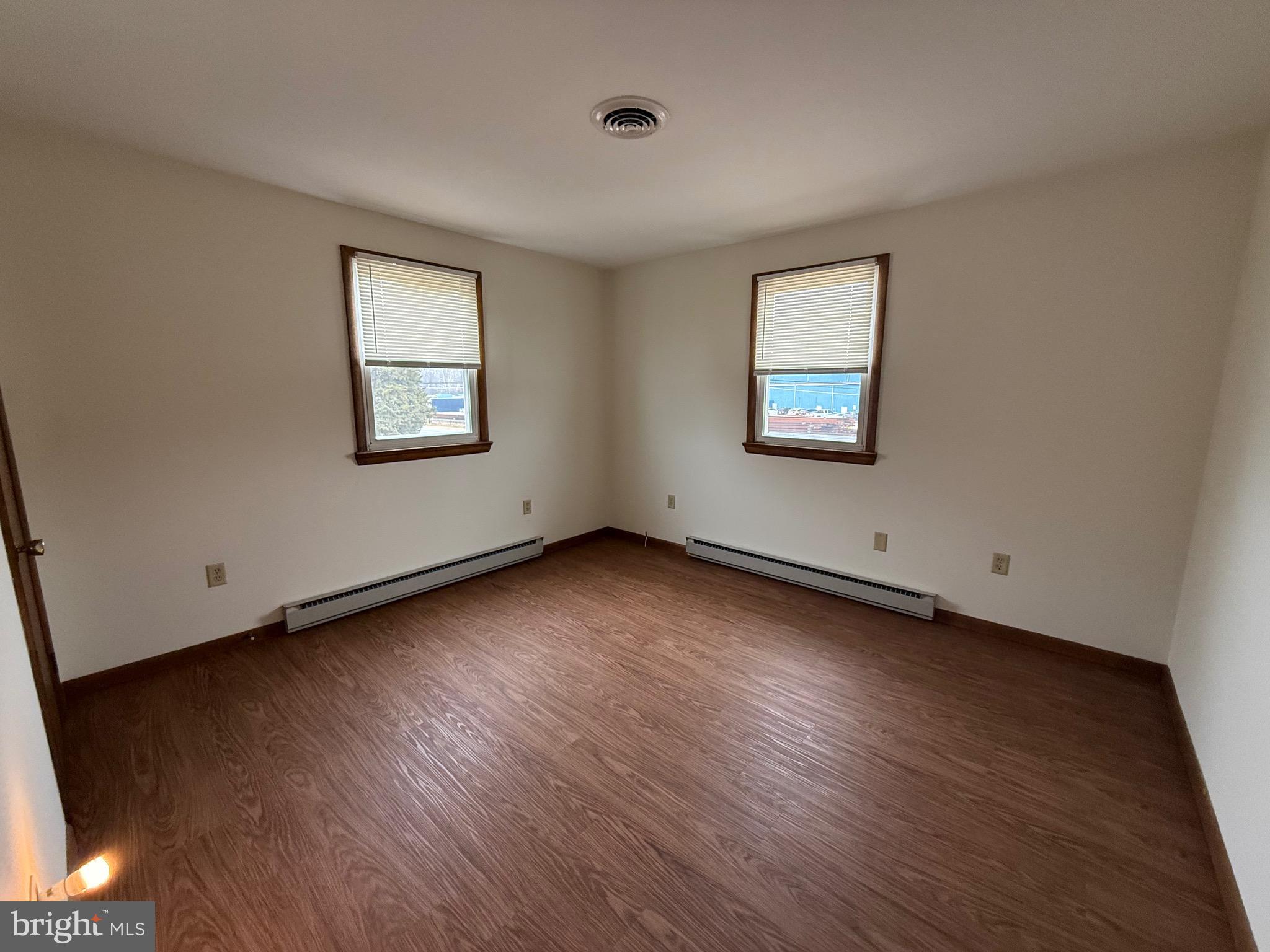 344 North Virginia Avenue Carneys Point, NJ 08069 - Photo 10 of 16 an empty room with wooden floor and windows