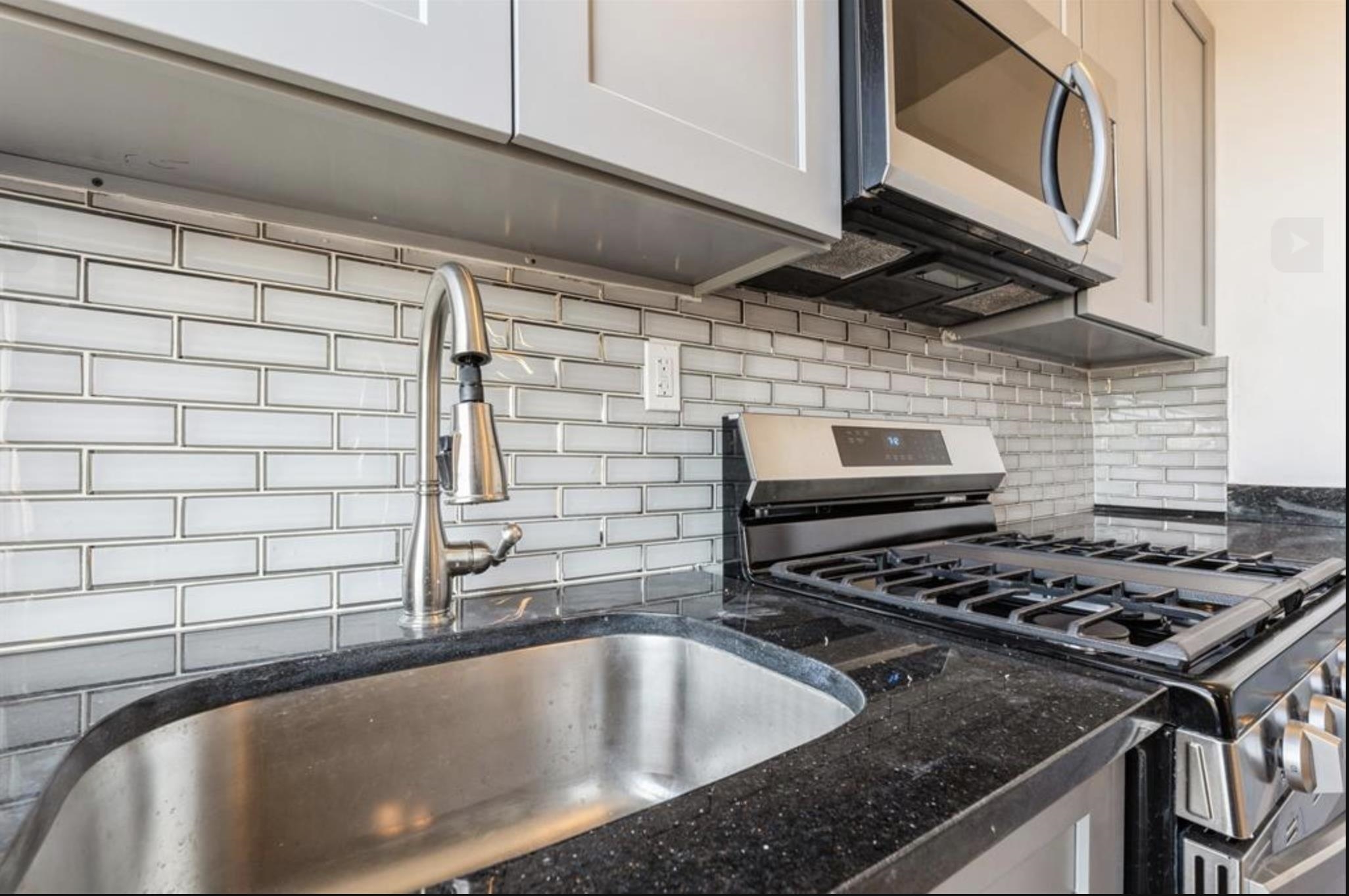 291 Forrest Street, Unit 2 Jersey City, NJ 07304 - Photo 11 of 17 a kitchen with a sink a stove and cabinets