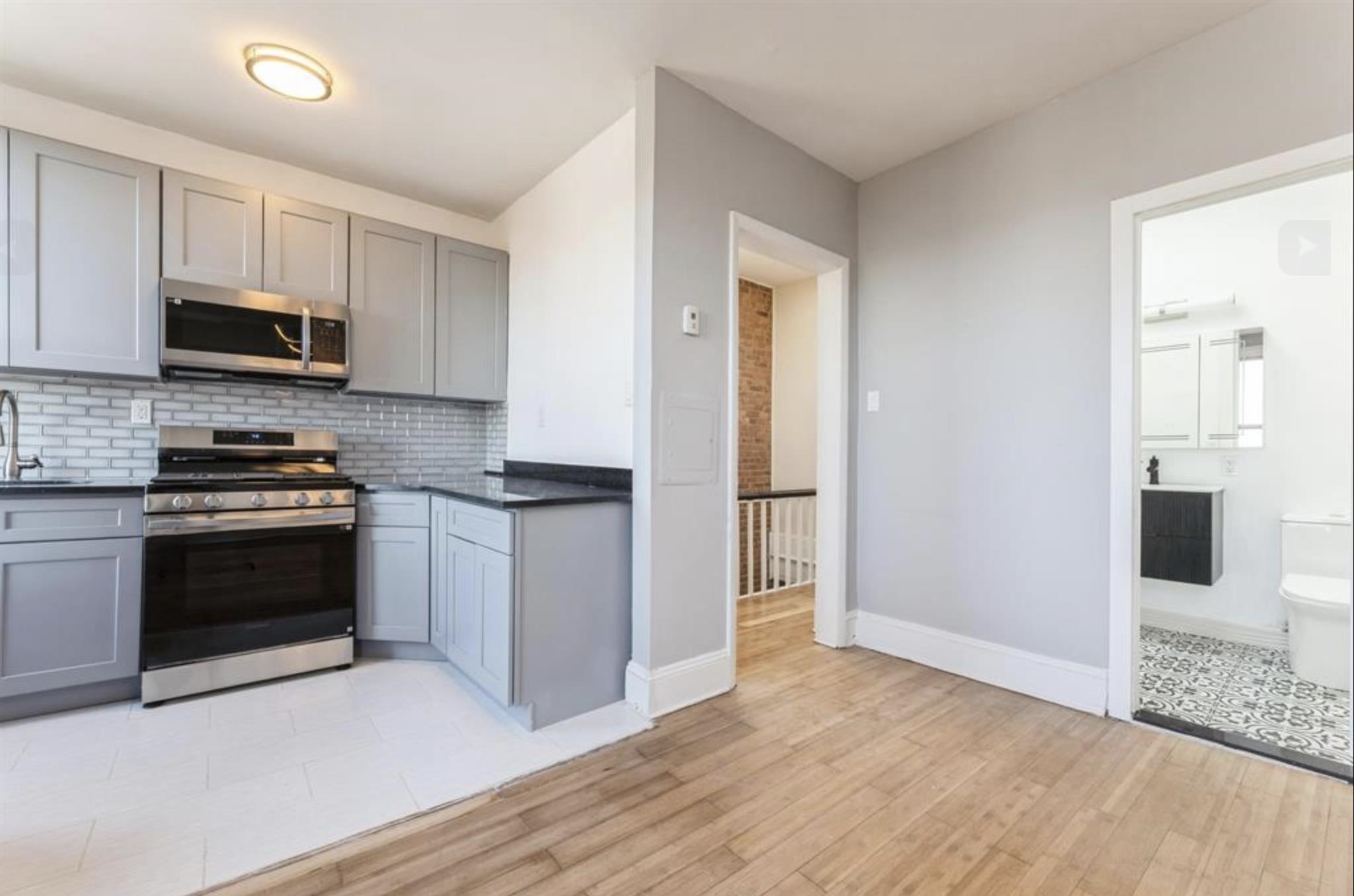291 Forrest Street, Unit 2 Jersey City, NJ 07304 - Photo 12 of 17 a kitchen with stainless steel appliances granite countertop a stove a sink and a refrigerator