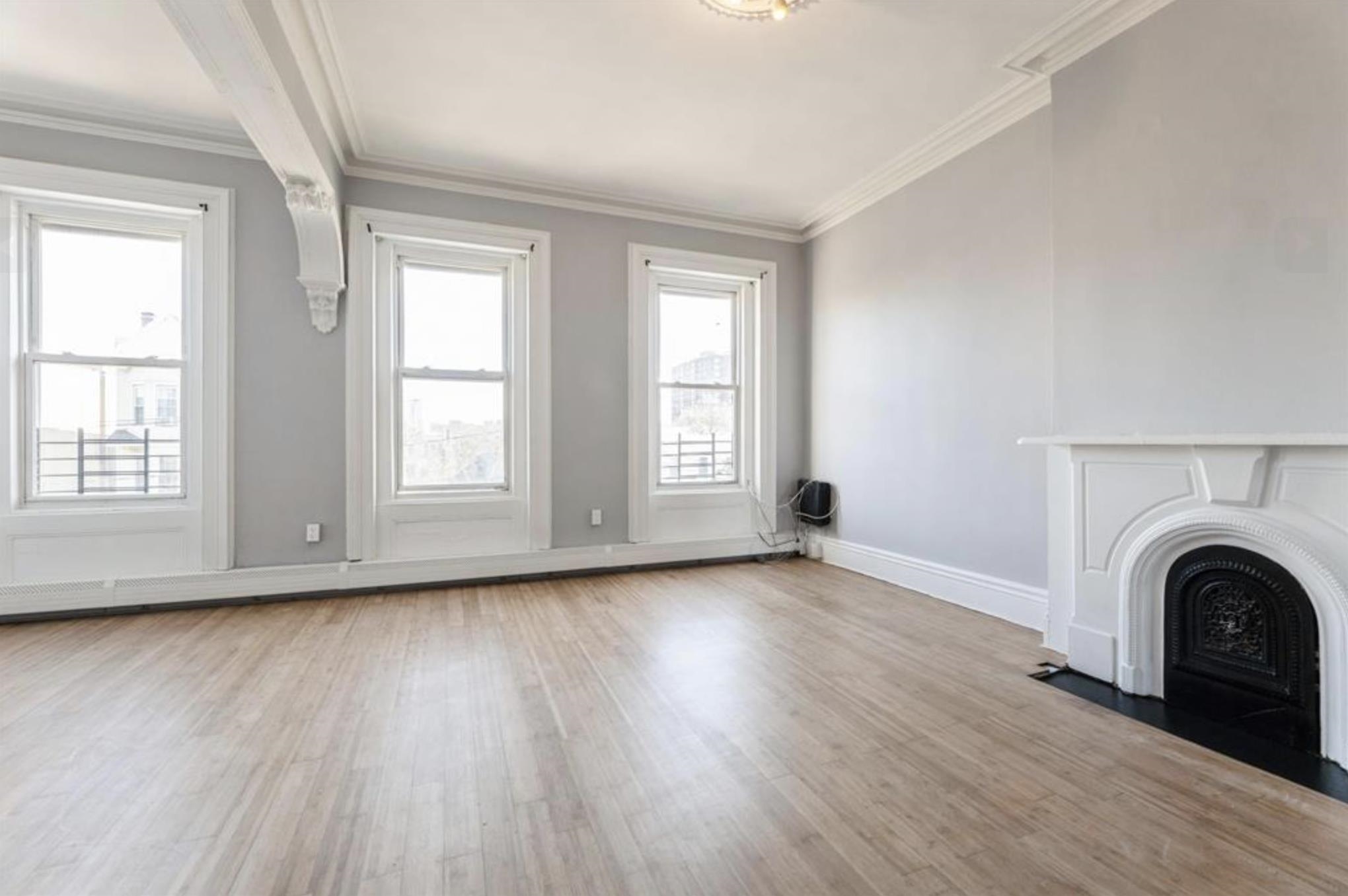 291 Forrest Street, Unit 2 Jersey City, NJ 07304 - Photo 6 of 17 an empty room with wooden floor and window