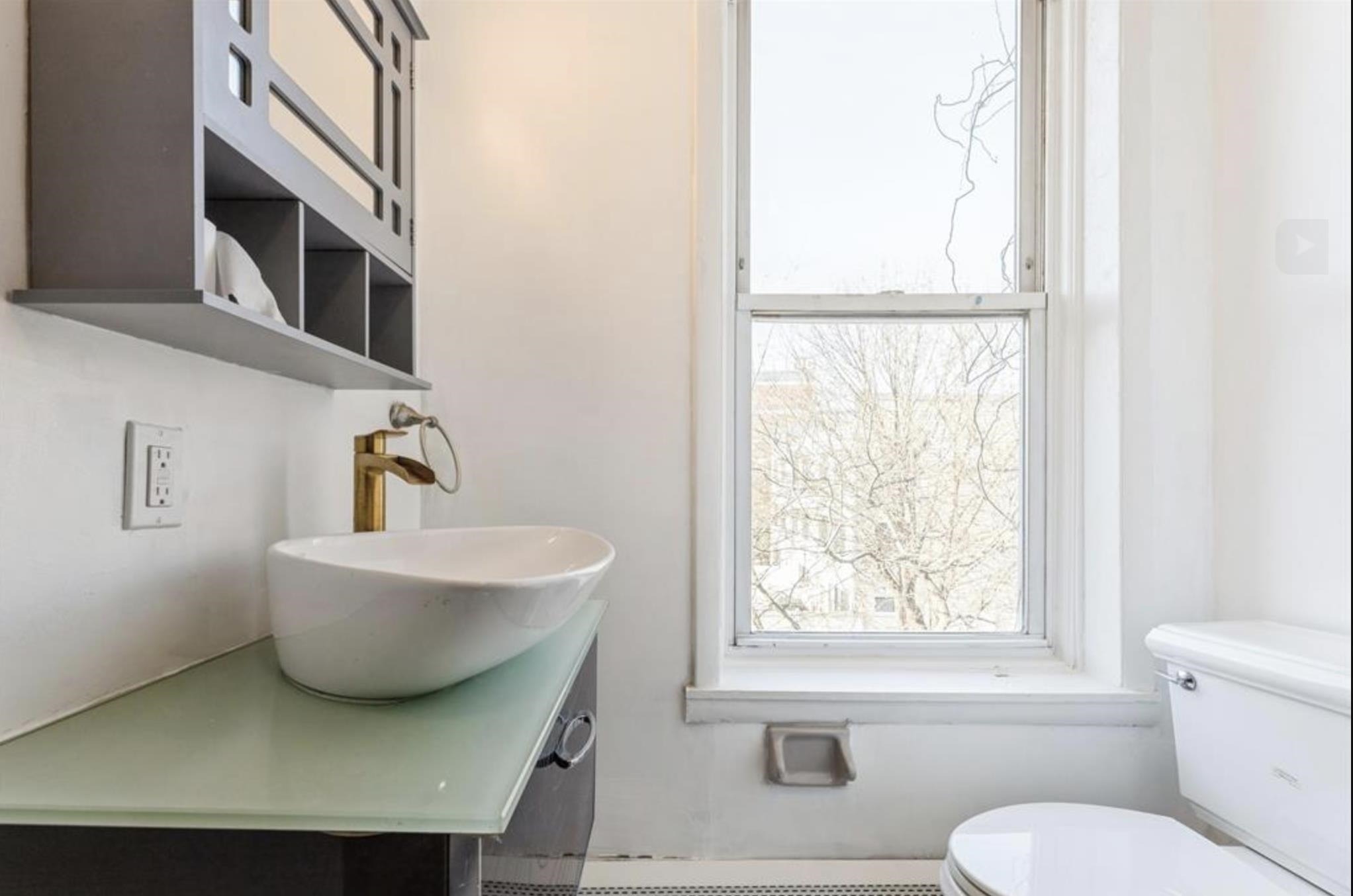 291 Forrest Street, Unit 2 Jersey City, NJ 07304 - Photo 7 of 17 a bathroom with a toilet a sink and a window