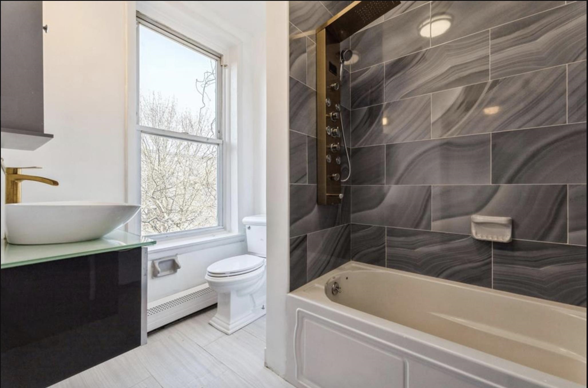 291 Forrest Street, Unit 2 Jersey City, NJ 07304 - Photo 8 of 17 a bathroom with a sink a toilet and bathtub