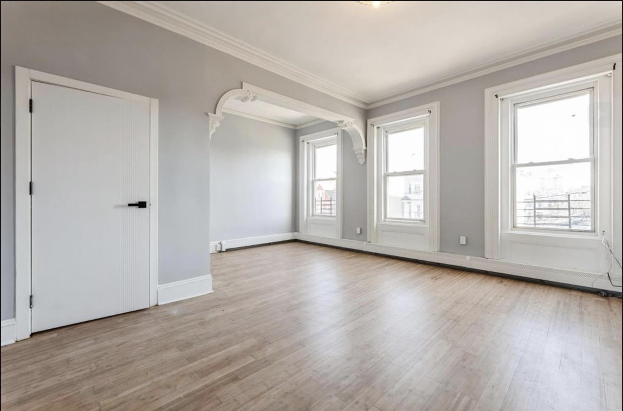 291 Forrest Street, Unit 2 Jersey City, NJ 07304 - Photo 9 of 17 a view of an empty room with wooden floor and a window