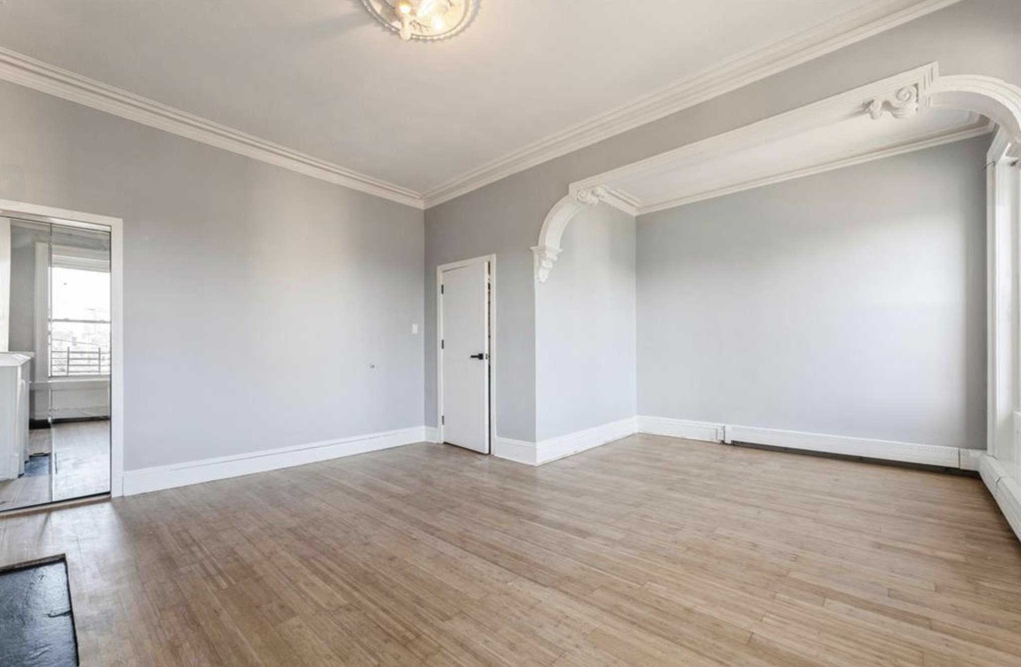 291 Forrest Street, Unit 2 Jersey City, NJ 07304 - Photo 10 of 17 a view of an empty room with wooden floor and a window