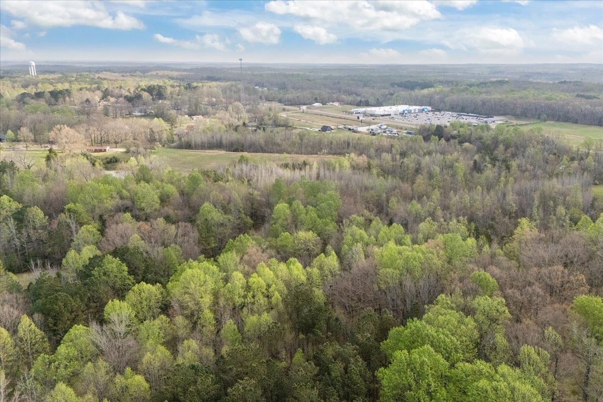 1759 McKelvy Road Camden, TN 38320 - Photo 18 of 20 an aerial view of residential houses with outdoor space and trees