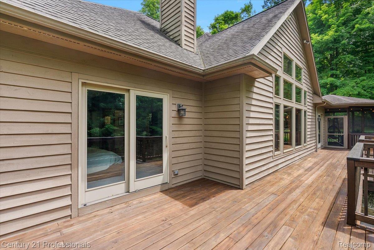 9867 Rainbow Ridge Drive Schoolcraft, MI 49087 - Photo 62 of 82 Expansive wood-finish deck with a sliding glass door entry, multi-pane picture windows, and a screened porch