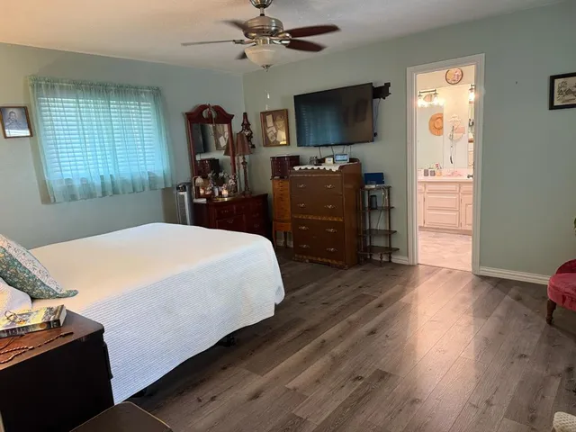 a bedroom with a bed and wooden floor