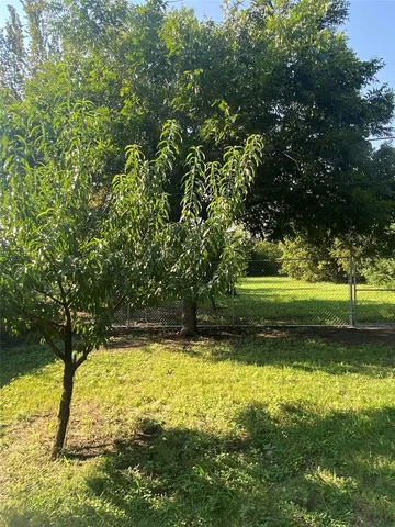 a view of a swimming pool with a yard