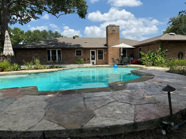 a front view of house with yard street and outdoor seating