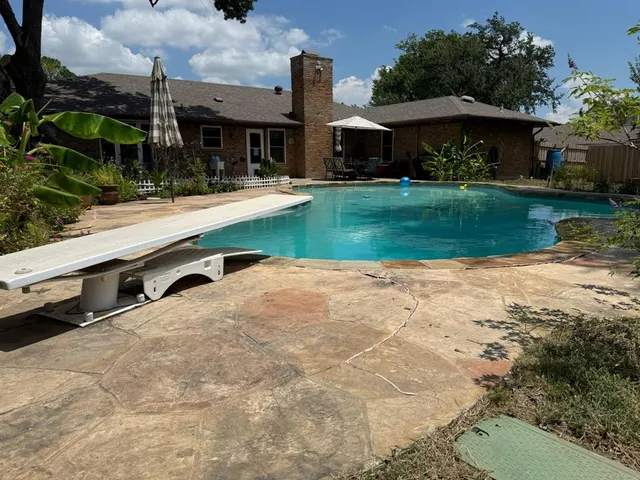 a view of a house with yard and sitting area