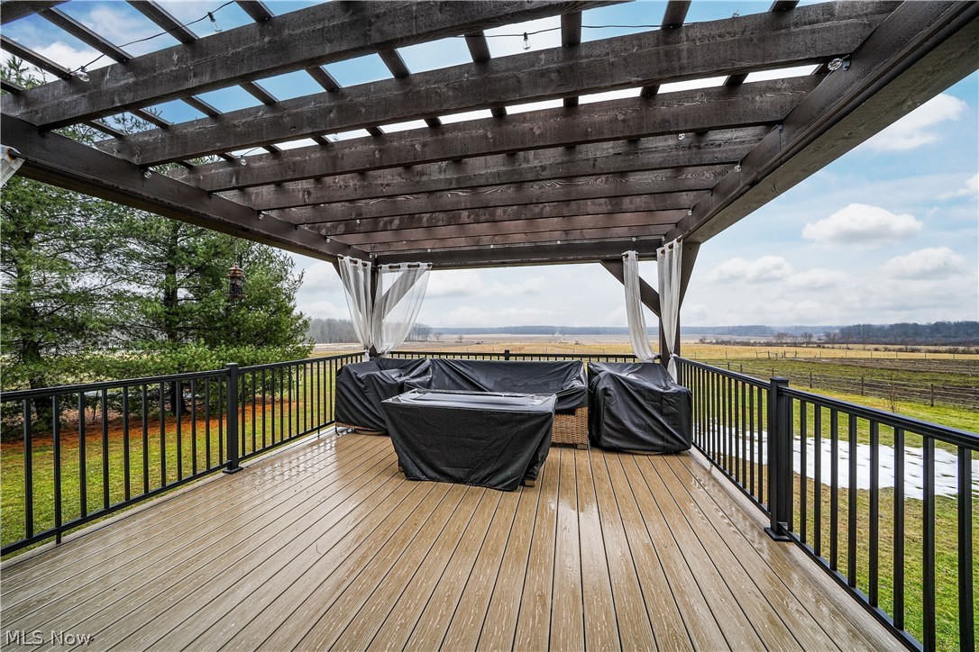 9561 Creaser Road North Bloomfield, OH 44450 - Photo 19 of 45 Deck with a pergola, grilling area, a view of countryside, and a lawn
