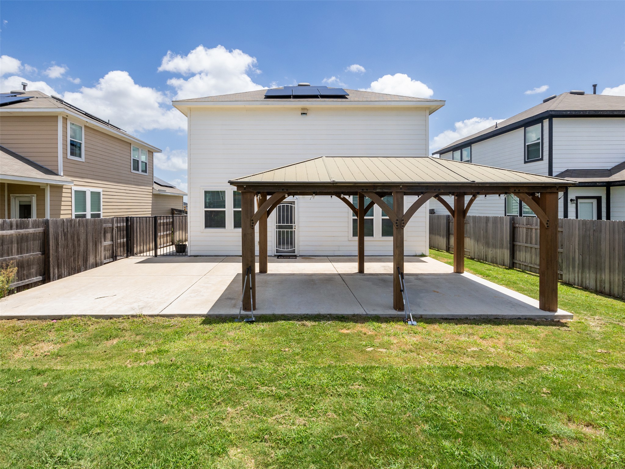 121 Graver Street Georgetown, TX 78626 - Photo 26 of 28 A spacious backyard with a generous patio and pergola, perfect for outdoor entertaining.