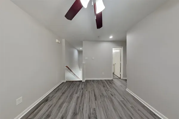 a view of an empty room with wooden floor