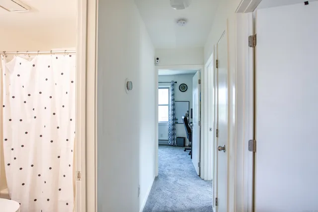 a view of a bathroom from a hallway
