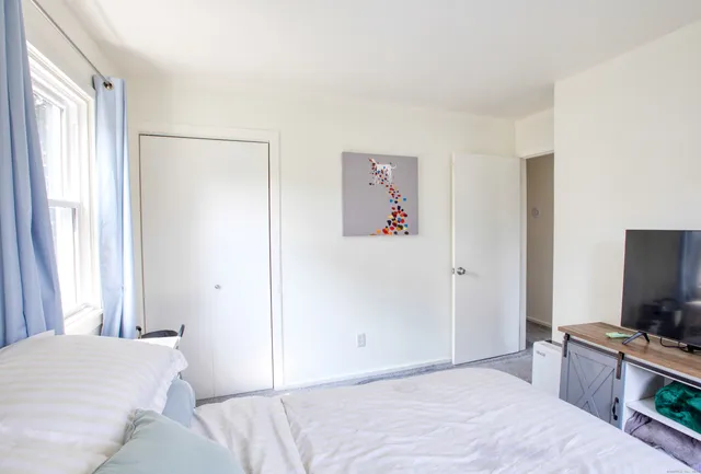 a bedroom with a bed and a flat screen tv