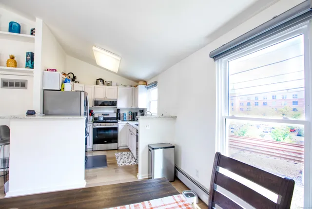 a kitchen with a refrigerator and windows
