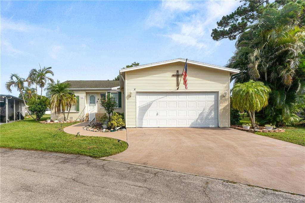 4237 4th Court Lantana, FL 33462 - Photo 1 of 40 a front view of a house with a yard and garage