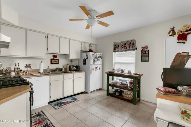 a kitchen with stainless steel appliances a stove a sink and a refrigerator