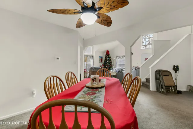 a dining room with furniture and a chandelier