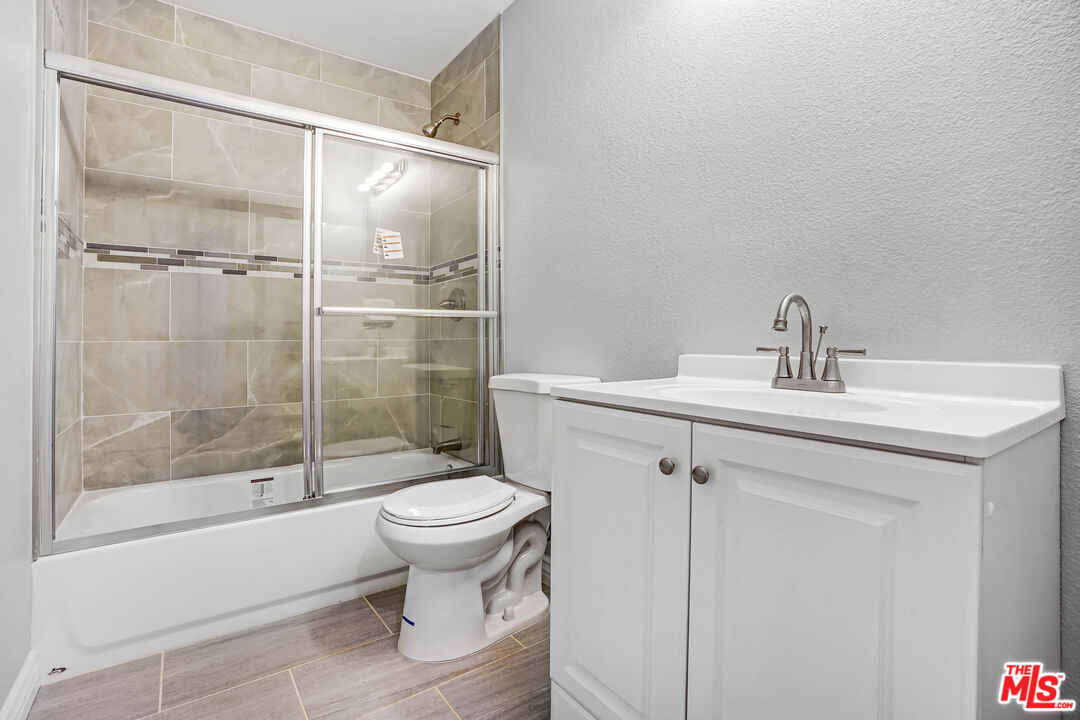 14416 Osage Road Apple Valley, CA 92307 - Photo 14 of 14 a bathroom with a sink toilet and shower