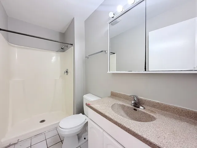 a bathroom with a sink toilet and shower