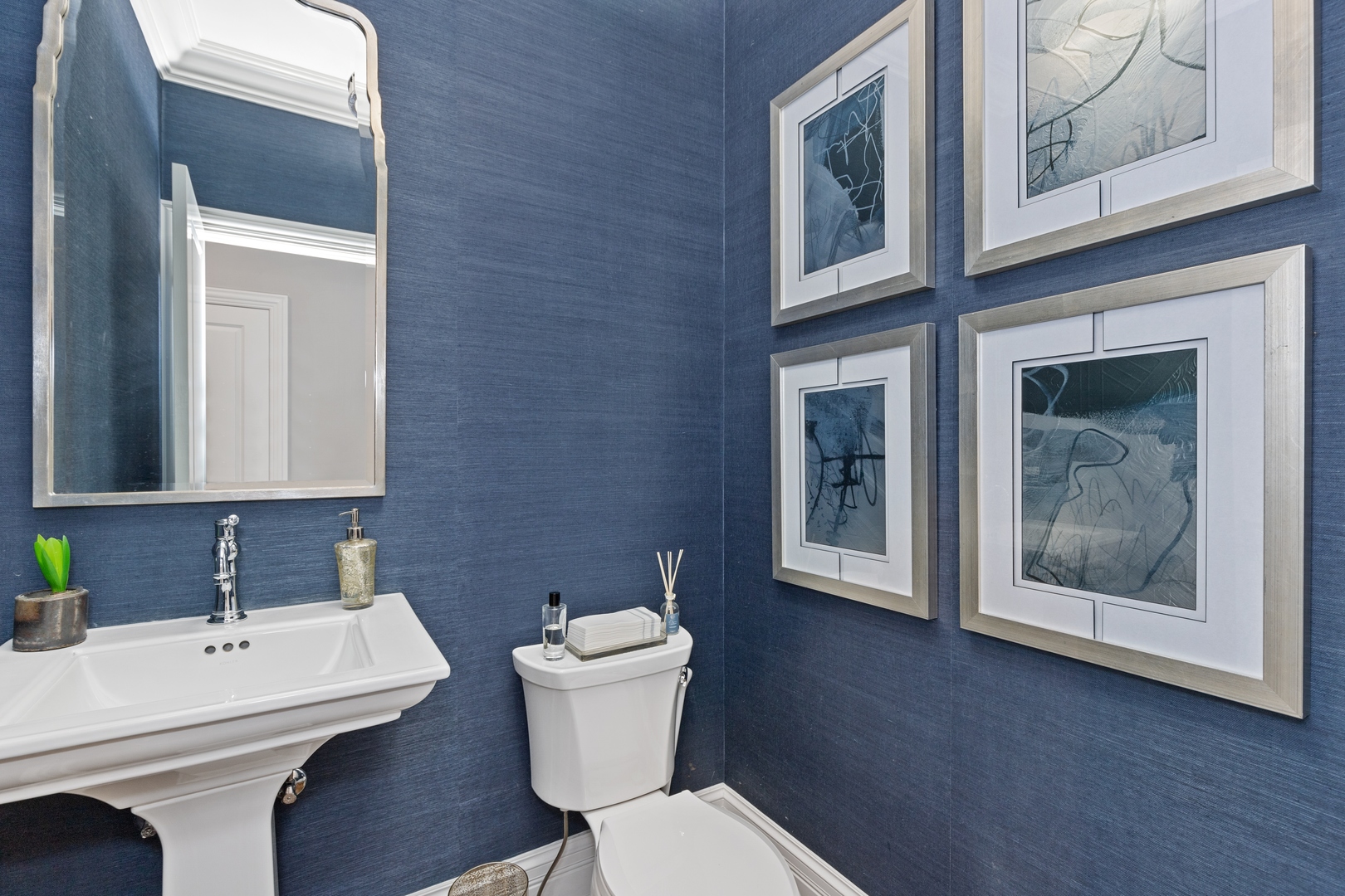 739 East Illinois Road Lake Forest, IL 60045 - Photo 33 of 39 a bathroom with a toilet a sink and mirror
