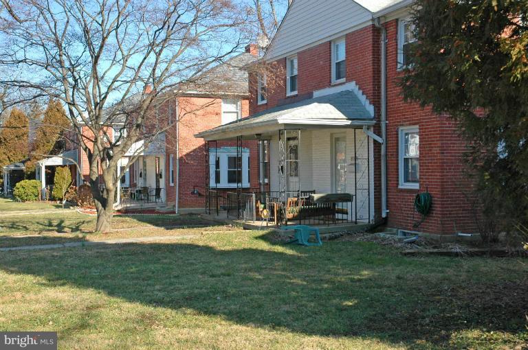 a view of a house with a yard patio and fire pit