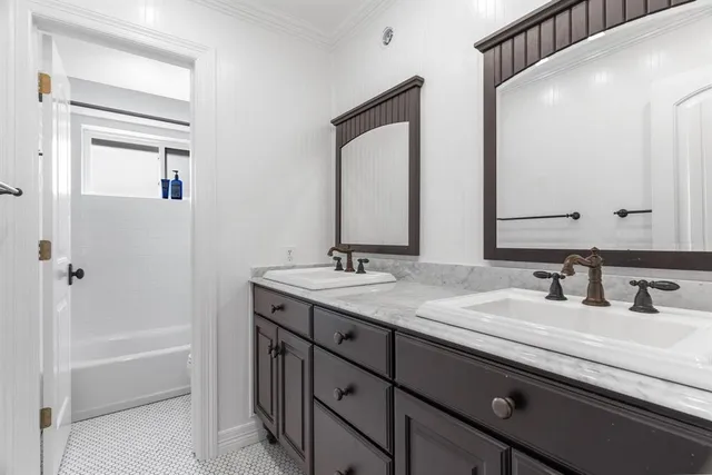a bathroom with a double vanity sink and a mirror