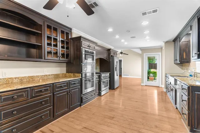 a kitchen with stainless steel appliances granite countertop a stove and a sink