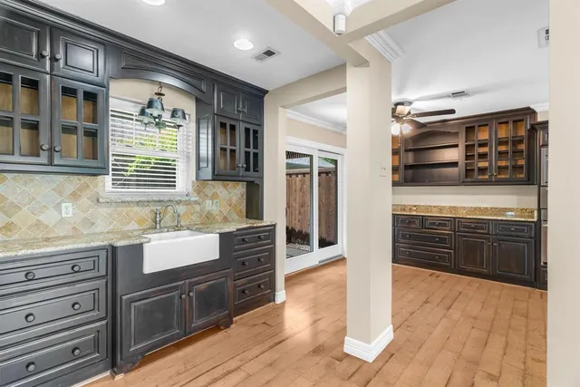 a kitchen with granite countertop a stove and cabinets